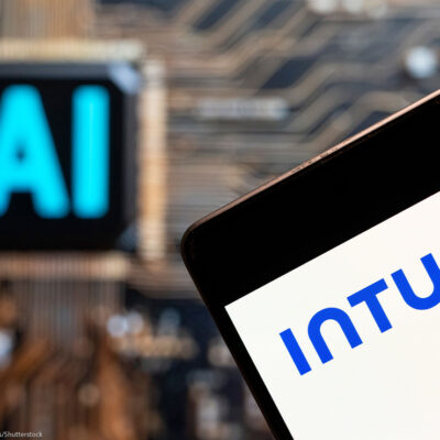 Software company Intuit logo seen displayed on a smartphone with an Artificial intelligence (AI) chip and symbol in the background.