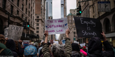 A group of demonstrators in Manhattan holding pro-democracy signage.