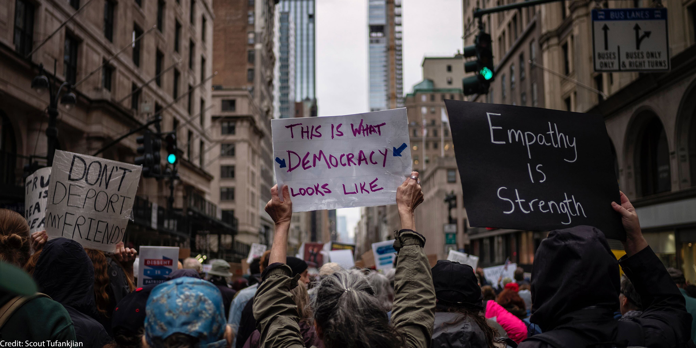A group of demonstrators in Manhattan holding pro-democracy signage.