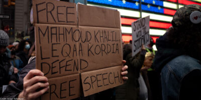 A demonstrator holding a sign in support of freeing activist Mahmoud Khalil.